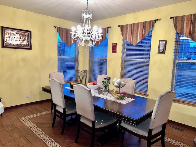 dining space with a notable chandelier and dark wood-type flooring