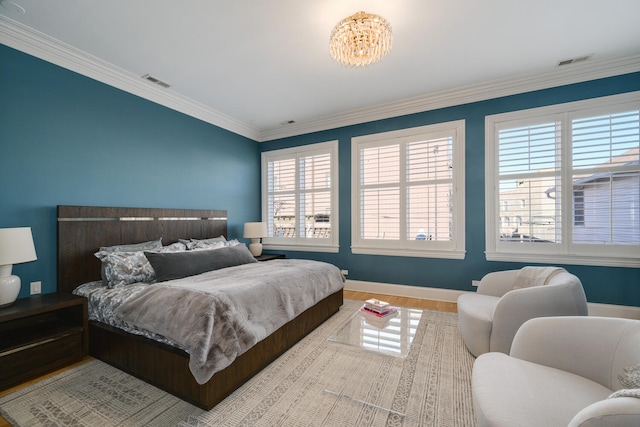 bedroom with wood-type flooring and ornamental molding