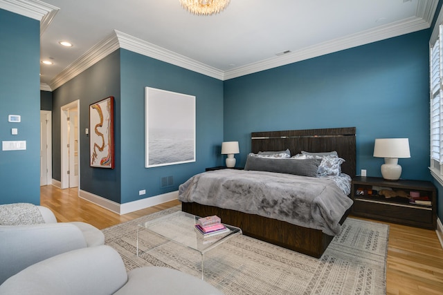 bedroom with ornamental molding and light hardwood / wood-style floors