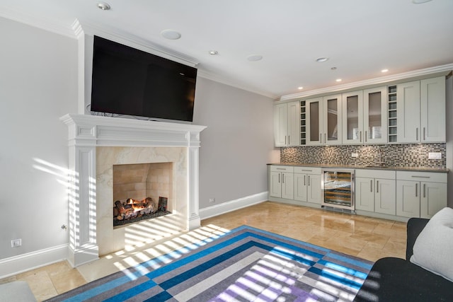 kitchen featuring gray cabinets, crown molding, wine cooler, and decorative backsplash