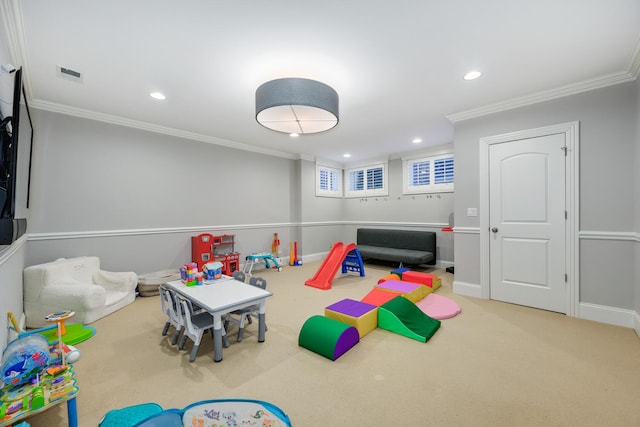 recreation room with crown molding and carpet flooring