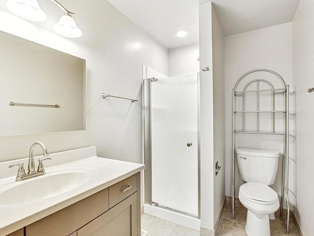 bathroom with vanity, tile patterned flooring, a shower with shower door, and toilet