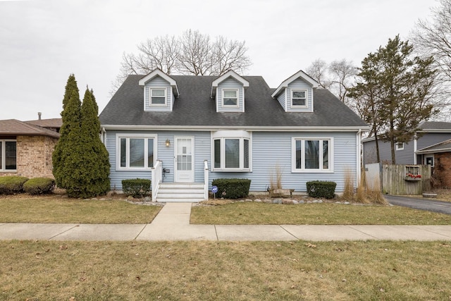 cape cod house with a front yard