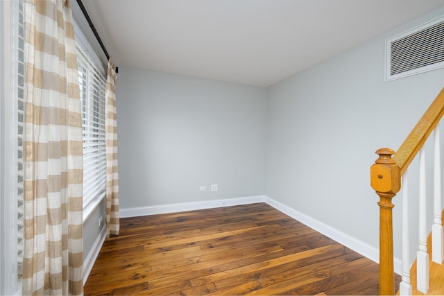 unfurnished room featuring dark wood-type flooring