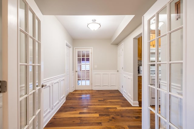 doorway with dark hardwood / wood-style floors and french doors