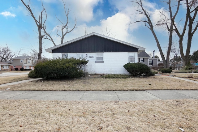 view of side of property with a lawn