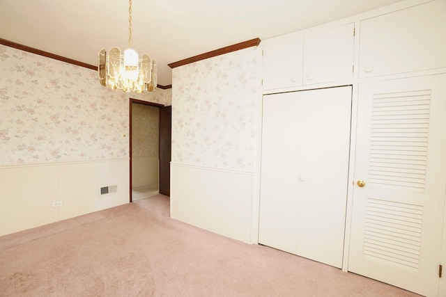 carpeted empty room with wood walls, visible vents, and ceiling fan