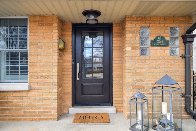 entrance to property with brick siding