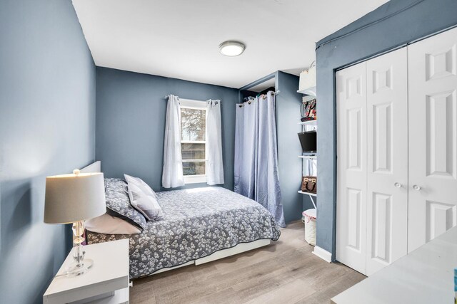 bedroom with a closet and wood finished floors