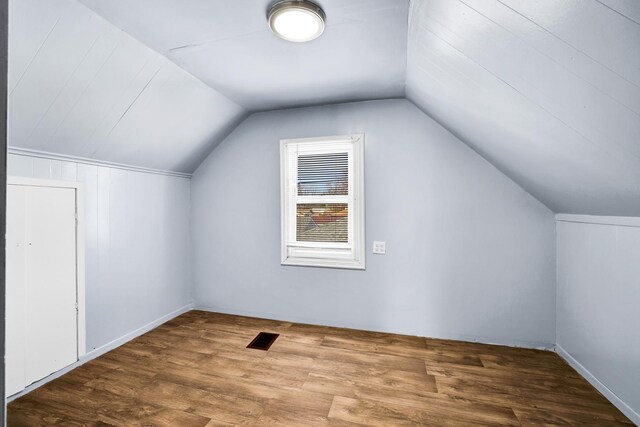 bonus room featuring vaulted ceiling, visible vents, and wood finished floors