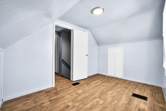 additional living space featuring visible vents, baseboards, and wood finished floors