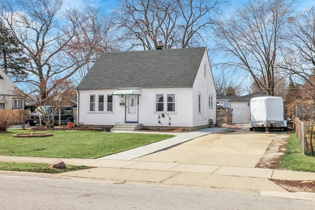 view of front of home featuring a shingled roof, entry steps, a front yard, an outdoor structure, and driveway