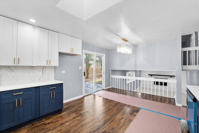 kitchen featuring white cabinetry, backsplash, blue cabinets, dark hardwood / wood-style flooring, and decorative light fixtures