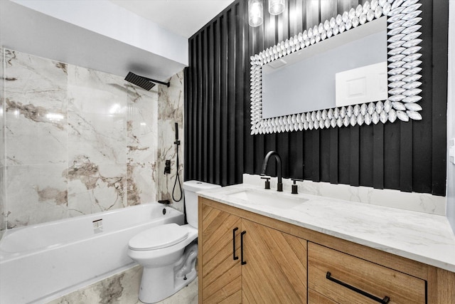 full bathroom featuring vanity, tiled shower / bath combo, and toilet