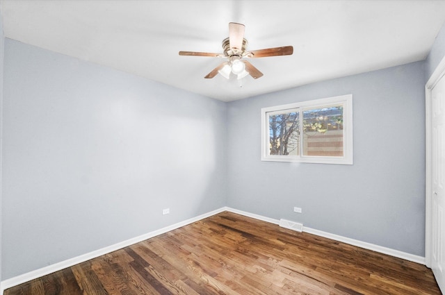 empty room featuring hardwood / wood-style floors and ceiling fan