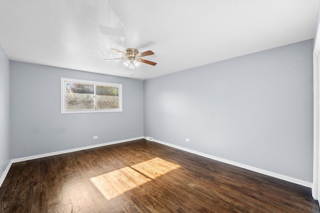 spare room with dark hardwood / wood-style flooring and ceiling fan