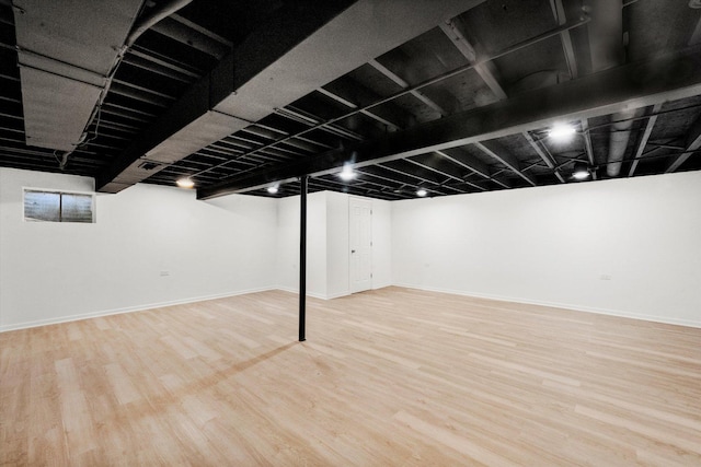 basement with hardwood / wood-style floors