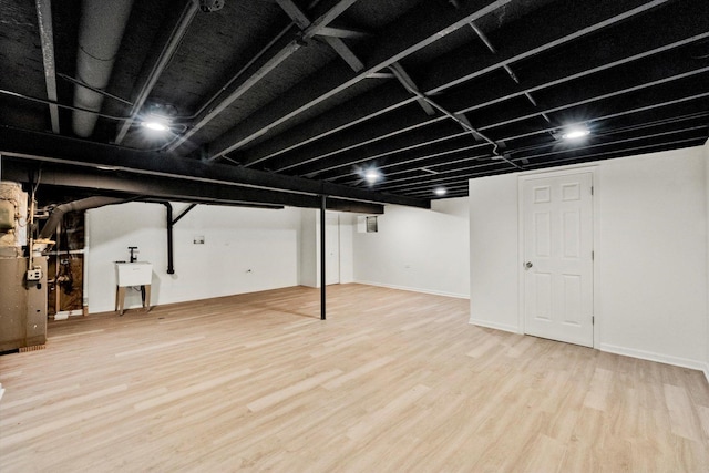 basement with sink and wood-type flooring