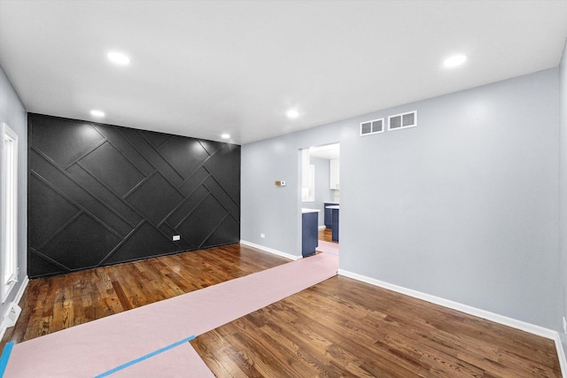 unfurnished room with hardwood / wood-style floors