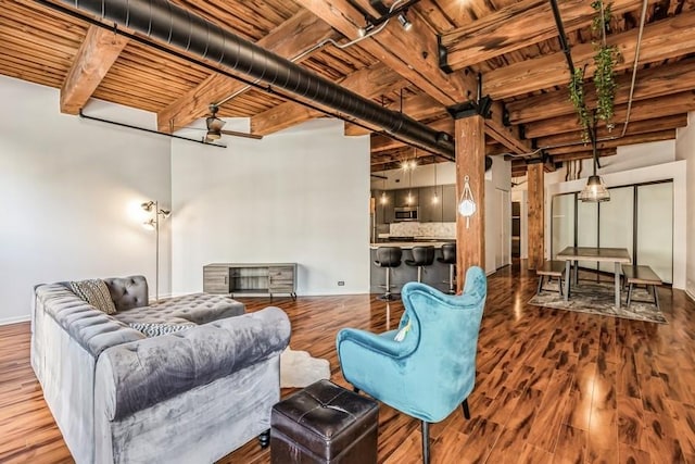 living room with wood-type flooring, beam ceiling, and wooden ceiling