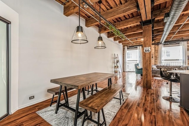 dining room featuring hardwood / wood-style floors, wooden ceiling, and beamed ceiling