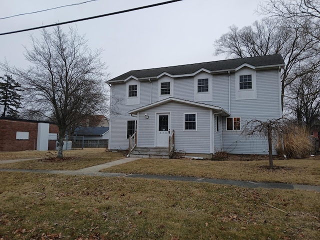 traditional-style home with entry steps and a front yard