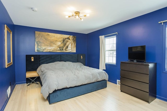 bedroom featuring baseboards and wood finished floors