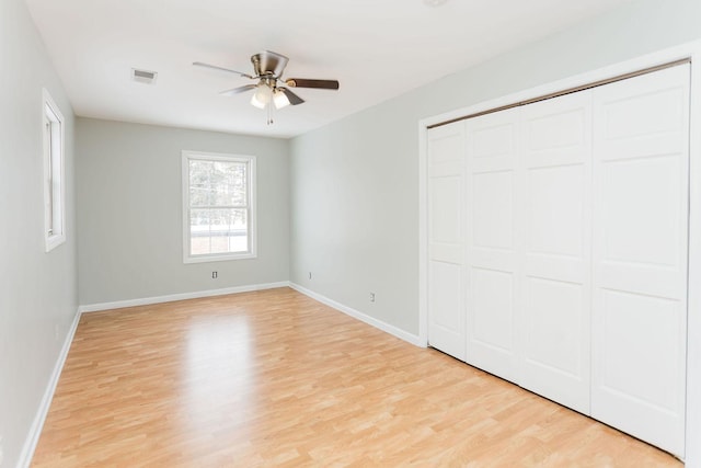 unfurnished bedroom featuring light wood-style floors, baseboards, and visible vents