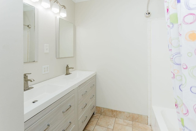 full bathroom featuring double vanity, bathtub / shower combination, and a sink