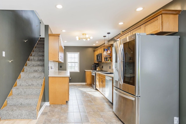 kitchen with stainless steel appliances, recessed lighting, light countertops, and decorative backsplash