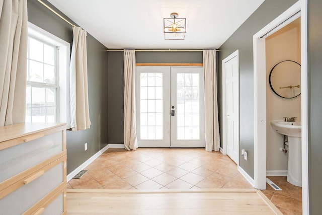 entryway with french doors, visible vents, baseboards, and light tile patterned floors