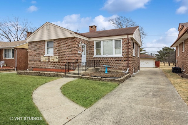 bungalow-style home featuring an outbuilding, a garage, and a front lawn