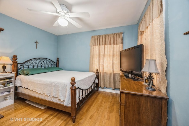 bedroom with hardwood / wood-style floors and ceiling fan