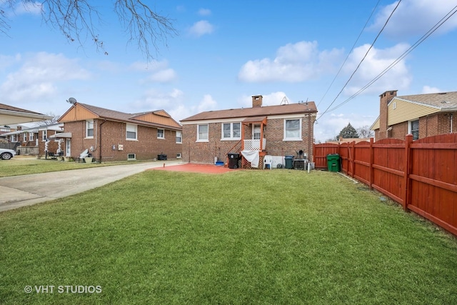 rear view of property with a lawn