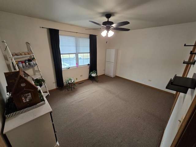 interior space with ceiling fan and carpet