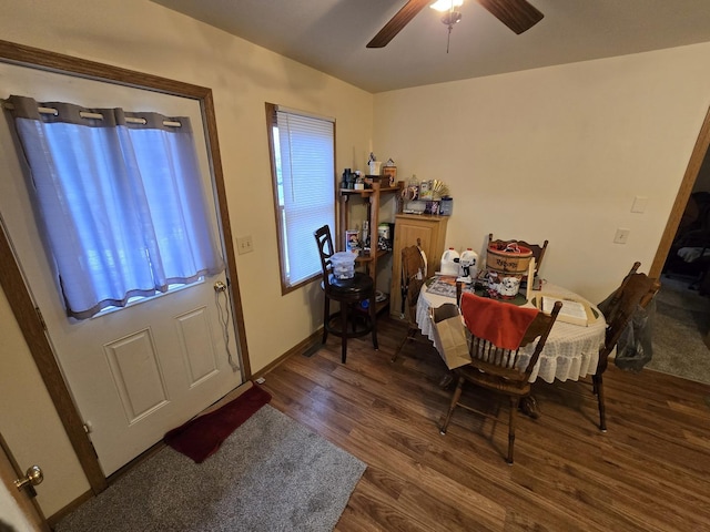 dining area with ceiling fan and dark hardwood / wood-style flooring