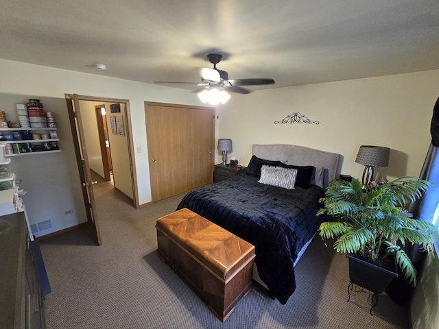 carpeted bedroom featuring ceiling fan and a closet