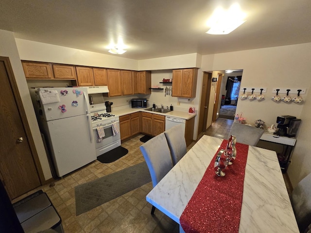 kitchen featuring white appliances and sink