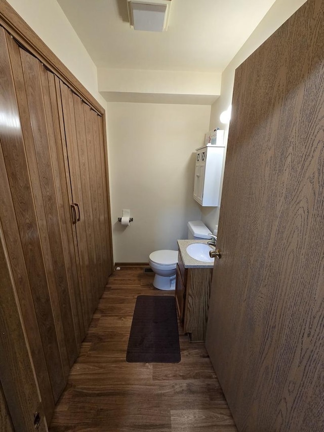 bathroom featuring hardwood / wood-style flooring, vanity, and toilet