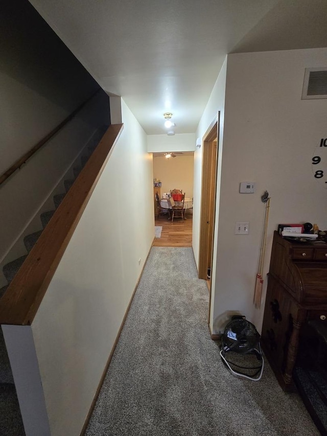 hallway with light colored carpet