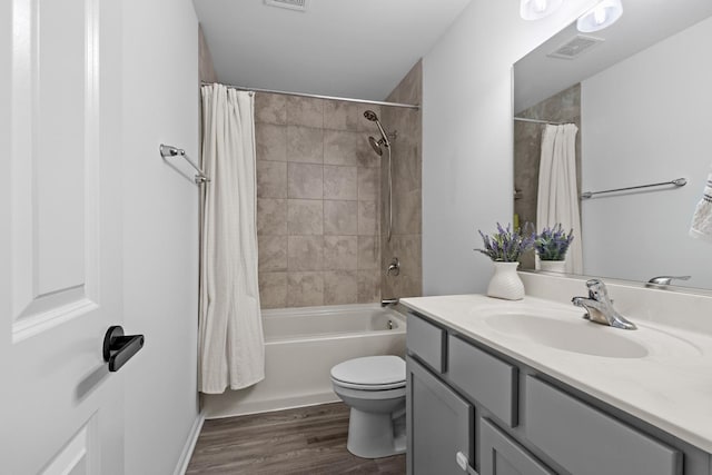 full bathroom with toilet, vanity, shower / bathtub combination with curtain, and hardwood / wood-style floors