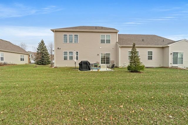 rear view of house featuring a yard and a patio area