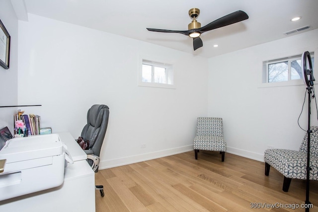 office space featuring ceiling fan, recessed lighting, visible vents, baseboards, and light wood-type flooring