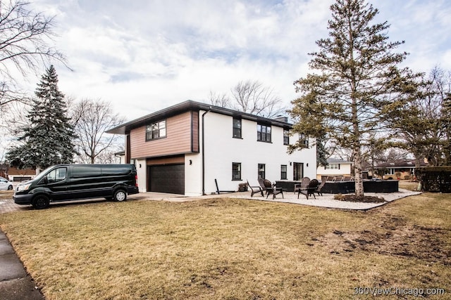 view of home's exterior with driveway, a garage, a patio, and a yard