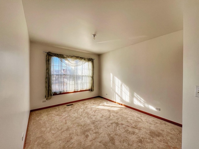 unfurnished room featuring carpet flooring