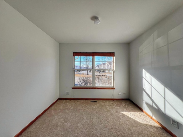 unfurnished room with light colored carpet