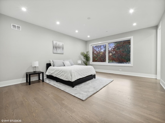 bedroom with hardwood / wood-style flooring