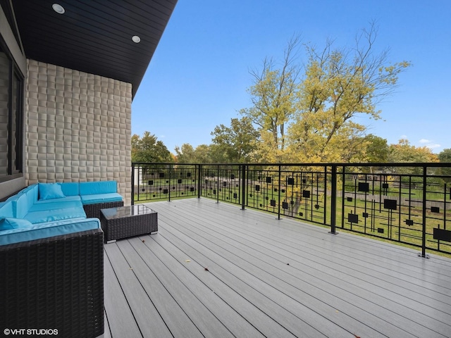 wooden deck with an outdoor living space