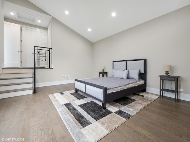 bedroom with vaulted ceiling and hardwood / wood-style floors