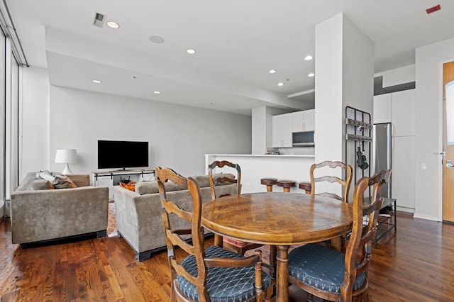 dining area with dark hardwood / wood-style floors